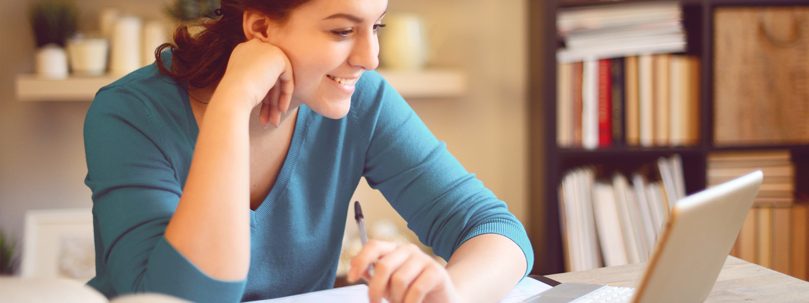 person smiling at laptop during online training